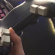 A PS4 DualShock controller with four keyboard buttons added to the back handles.